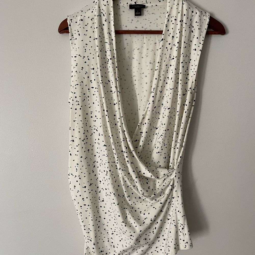 Faux wrap sleeveless shell. Print has a touch of dark green.